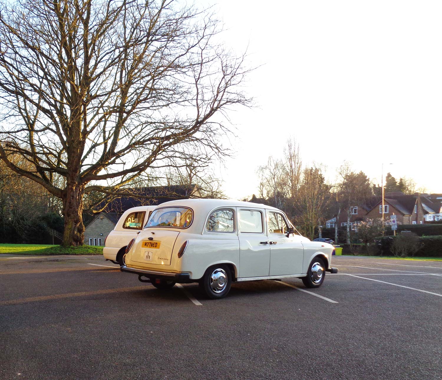 Classic white wedding taxi rear three-quarter view