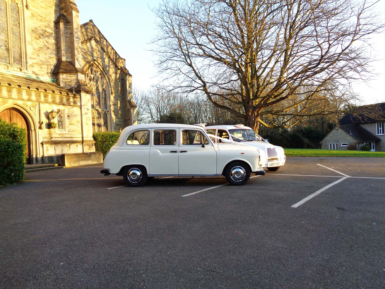 White wedding taxis waiting outside the church