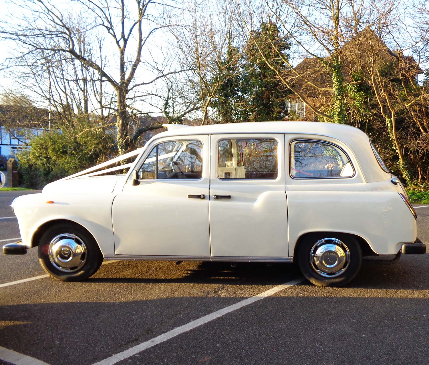 White London wedding taxi side profile with ribbons