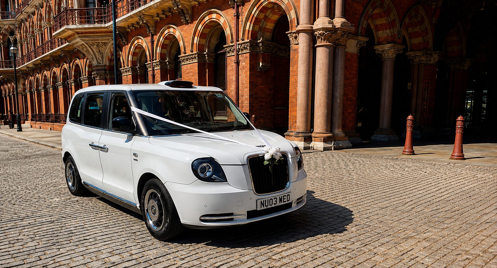 White electric TXE wedding taxi with ribbons and flowers outside St Pancras, London