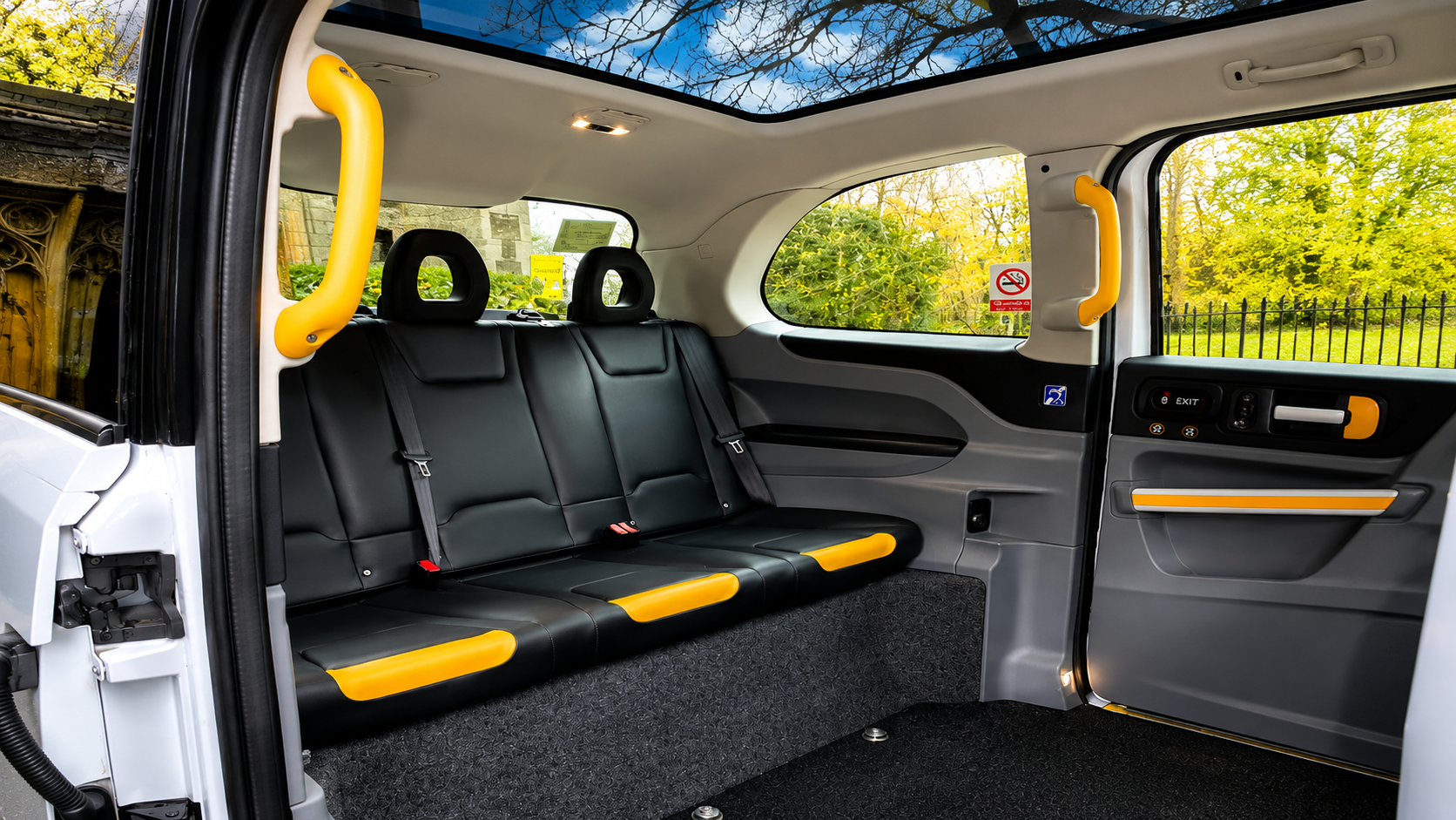 Rear passenger seats and panoramic roof inside the Classic Fairway wedding taxi